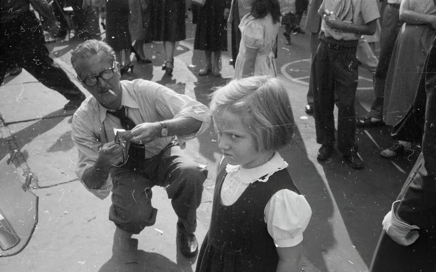 A little girl resents having her silhouette cut out by an artist in Washington Square, 1955.