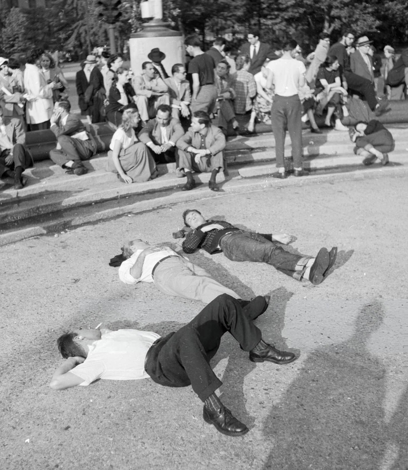 People relax in the sunshine in Washington Square, 1955.