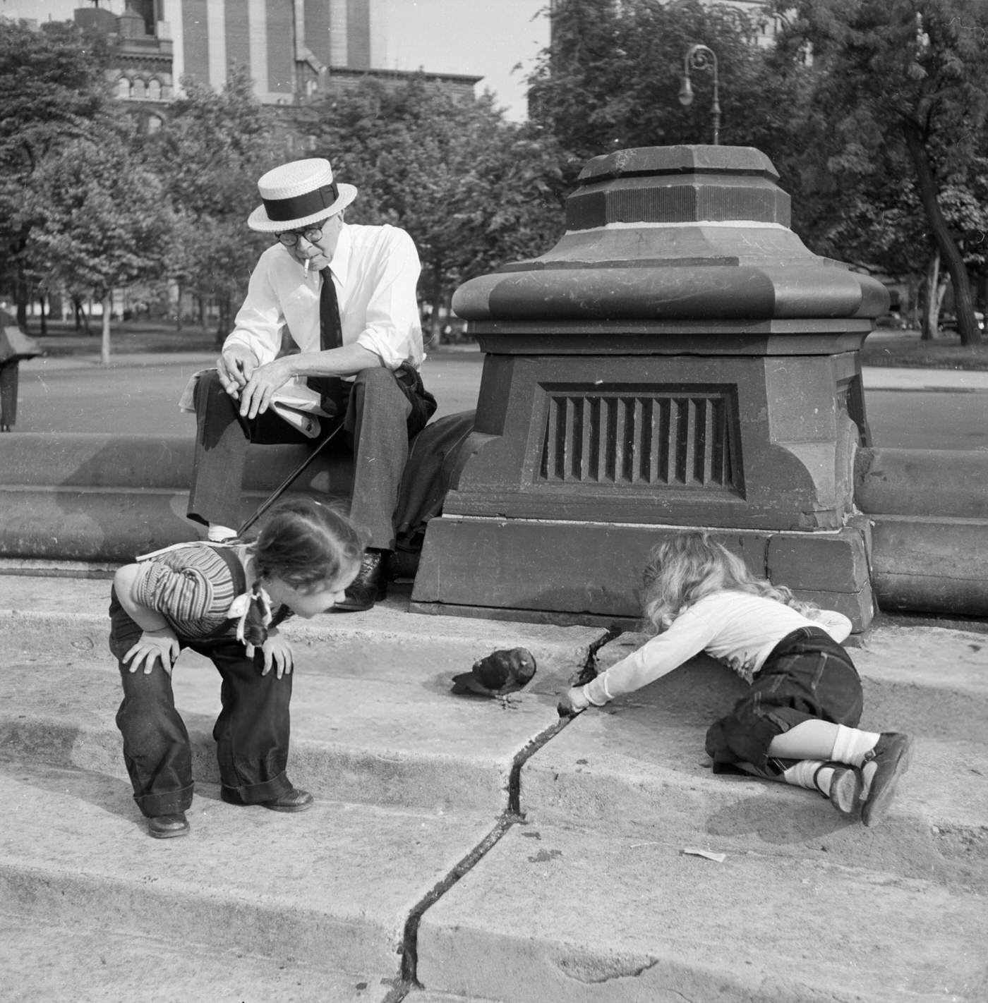 Two little girls playing with a pigeon in Washington Square Park, 1955.