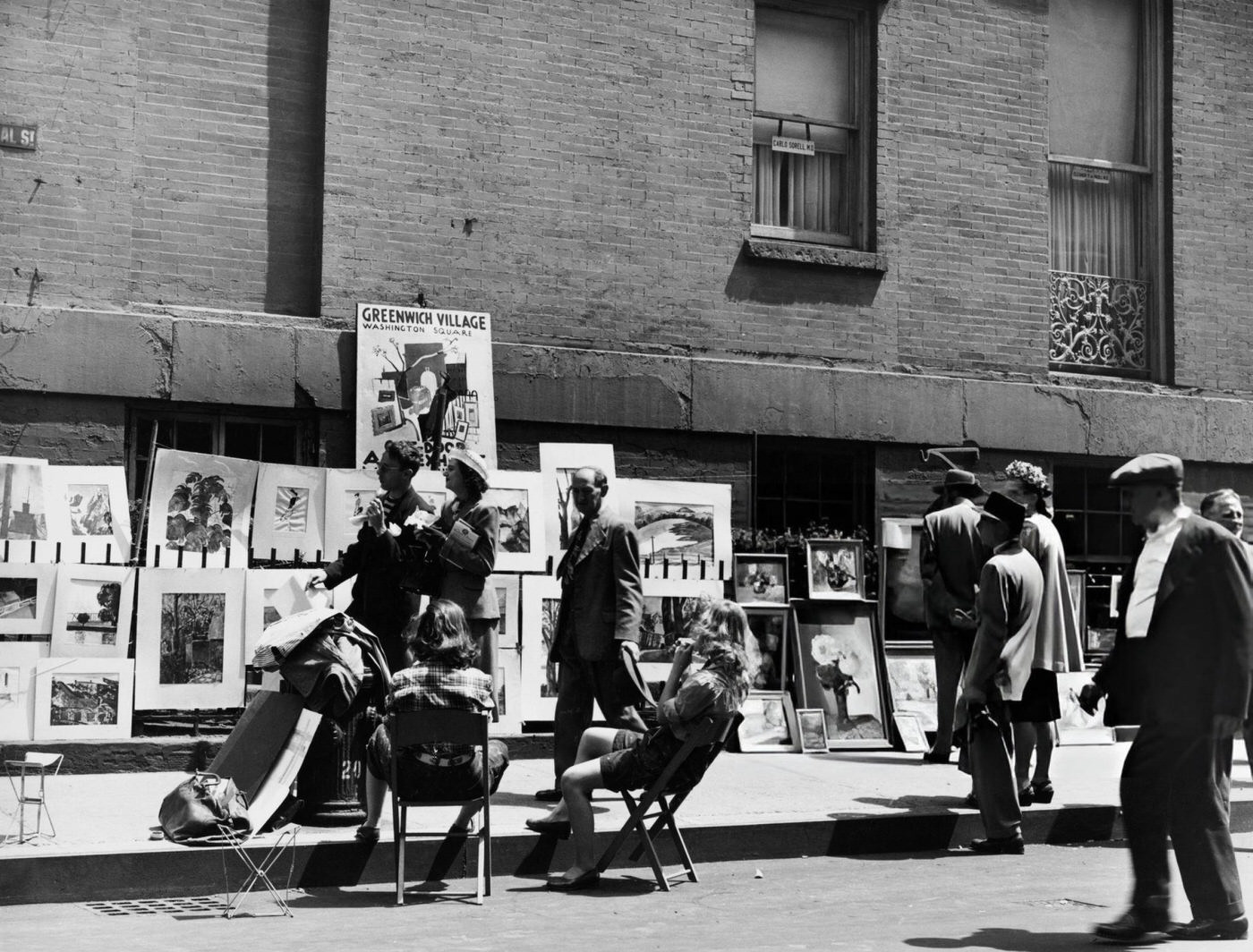 People at a sidewalk art exhibition in Greenwich Village, 1955.