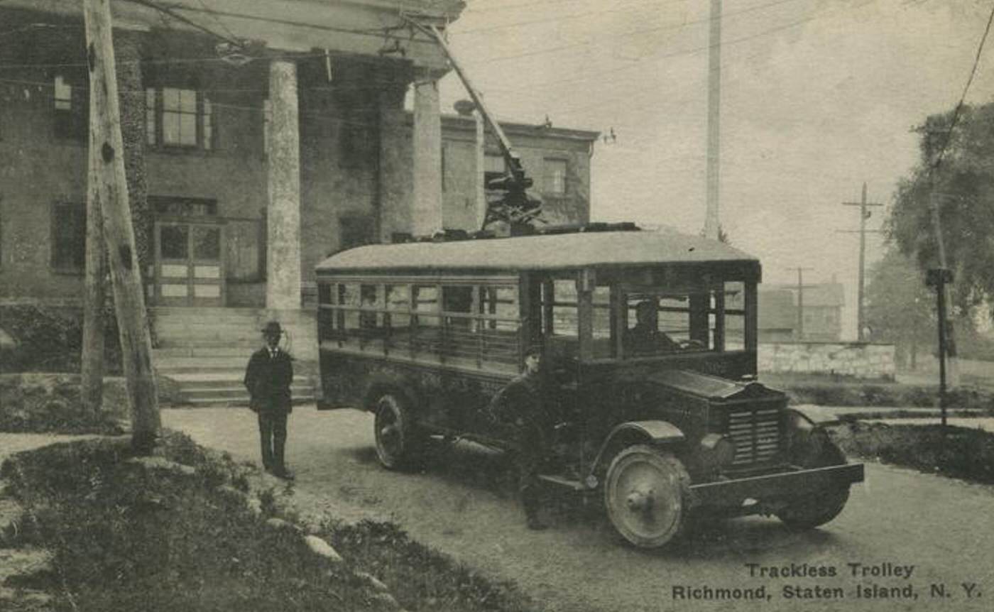 Trackless Trolley, Richmond, featuring an old bus and men standing outside, 1900s.