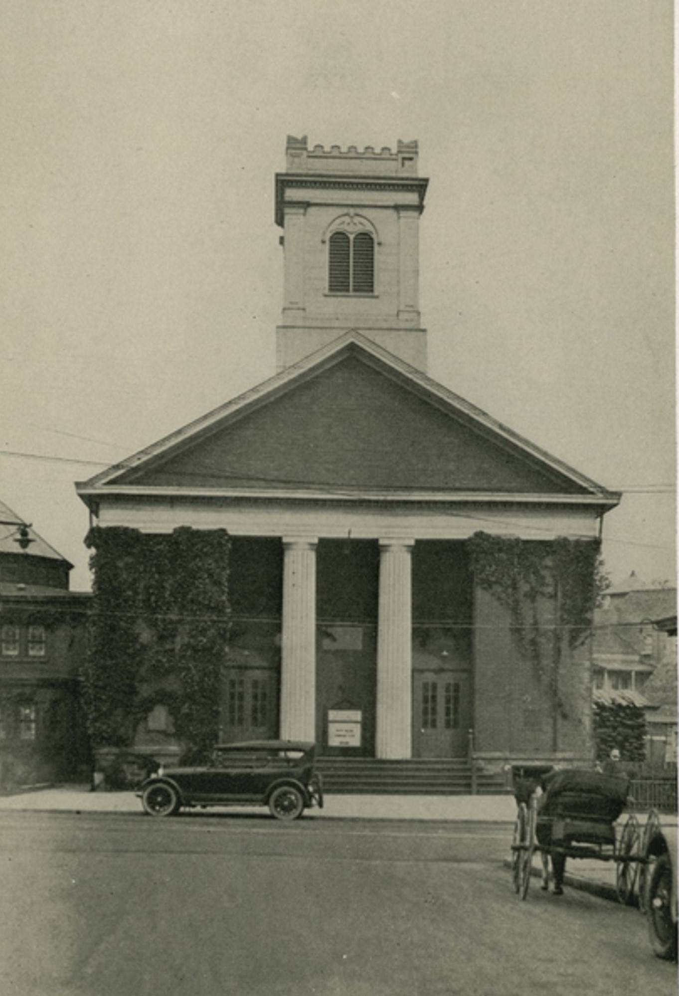Dutch Reformed Church, Port Richmond, Staten Island, featuring an old car and horse carriage in the street, 1900s.