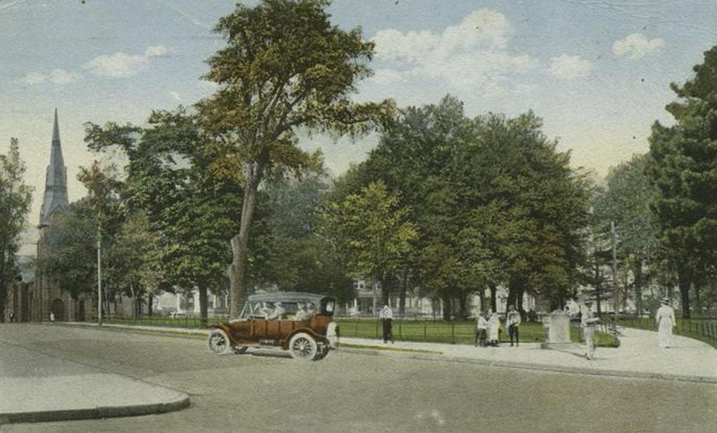 Public Park, Port Richmond, featuring people on the sidewalk and an old touring car on the street, 1900s.