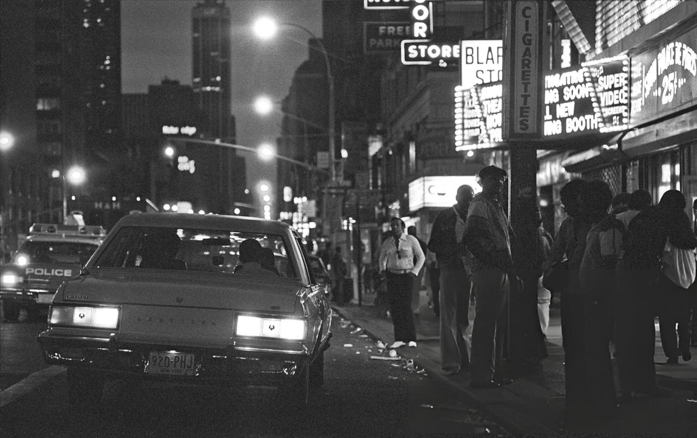 The night scene on 8th Ave and Times Square's W 42nd Street, New York, 1980.