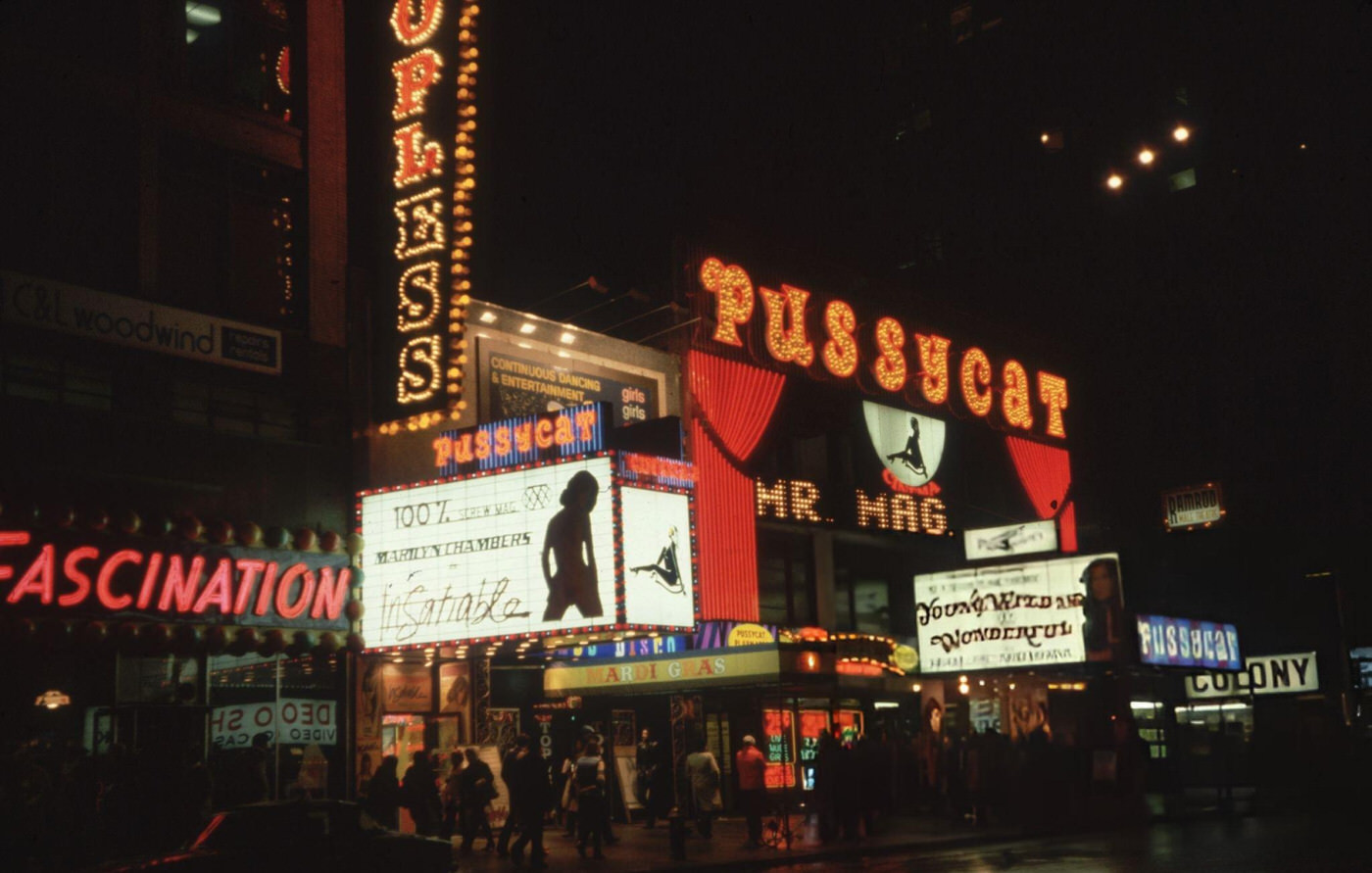 The Pussycat, an X-rated movie theater on 42nd Street in Times Square, advertising the film 'Insatiable', 1980.