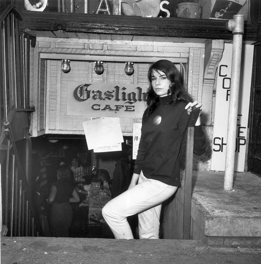 A beatnik woman stands in front of the Gaslight Cafe, Greenwich Village, 1959.