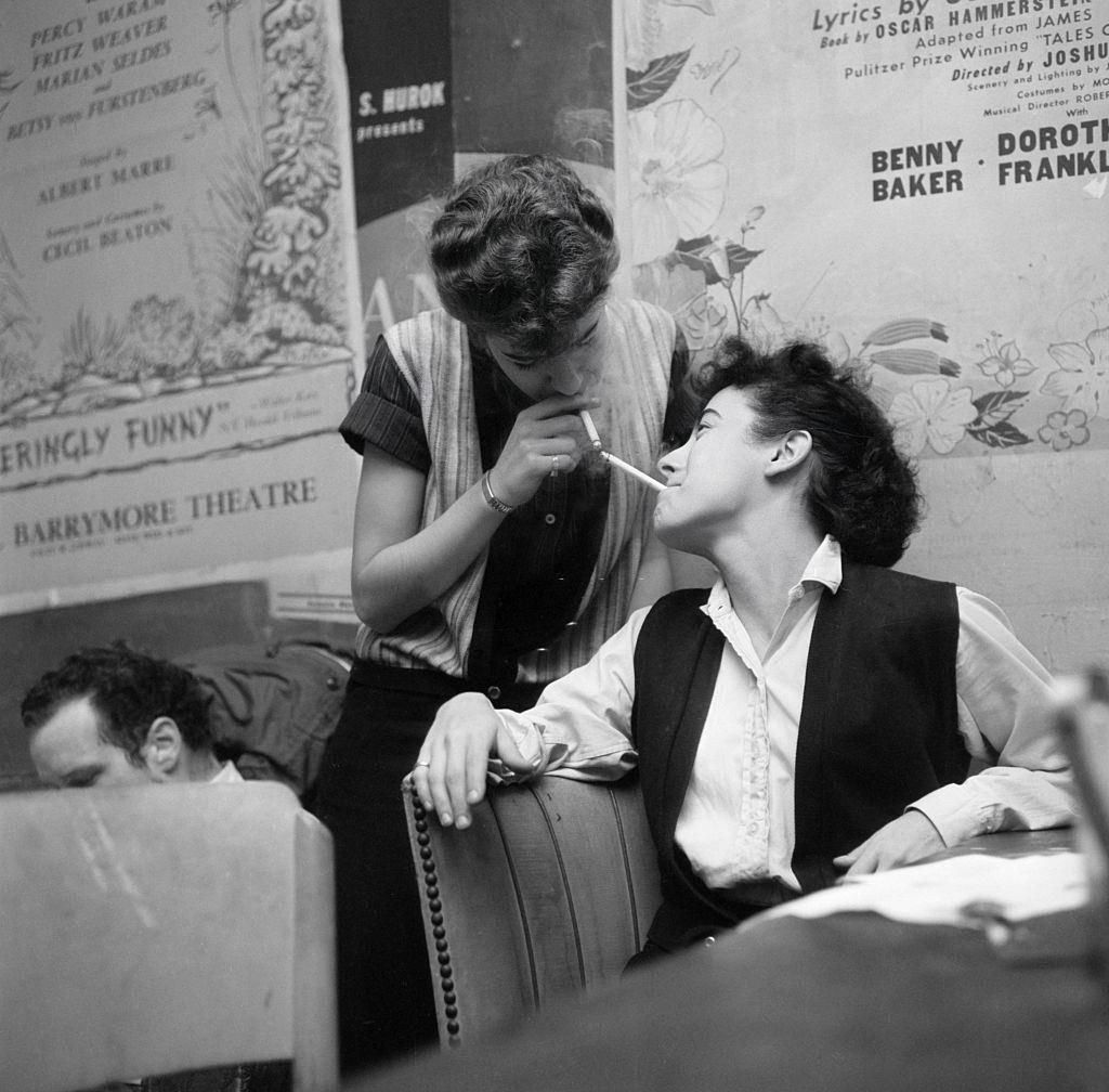 Beatniks at the Cock N' Bull lighting cigarettes off each other, 1959.