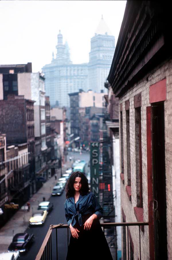 Mimi Margaux enjoys the view from the balcony in an East Village hangout, 1959.
