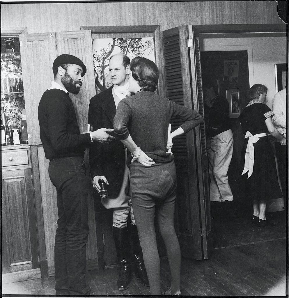 Ted Joans speaks with guests at a 'Rent-a-Beatnik' party, 1960.