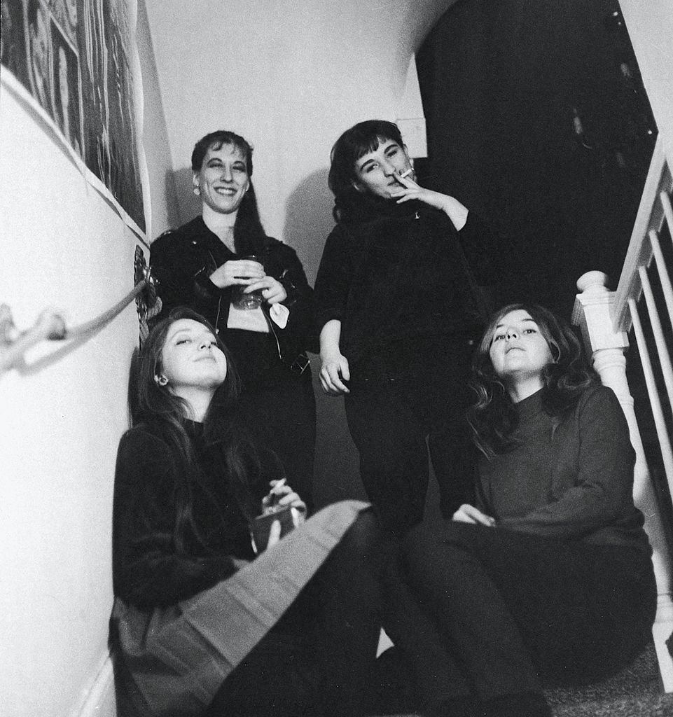 Female attendees at a 'Rent-a-Beatnik' party smoke in Sniffen Court, New York, 1960.