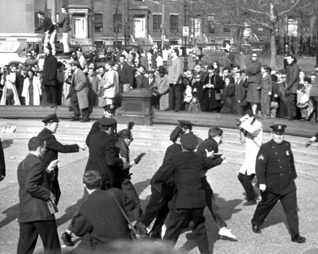 Police officers arrest beatnik demonstrators in Washington Square Park, 1961.