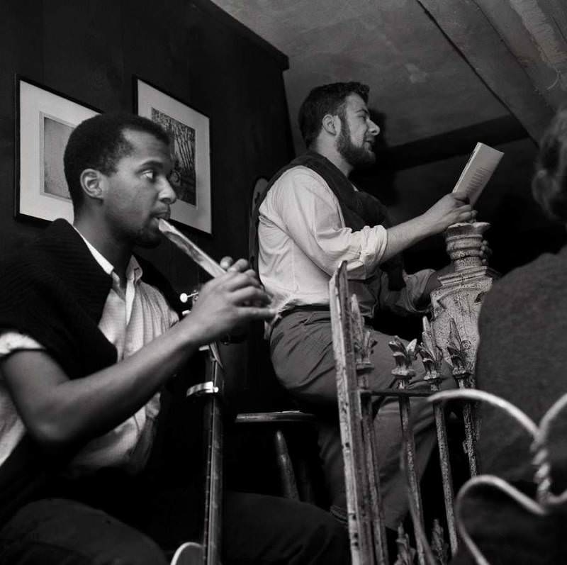 A man recites poetry with a flutist on Thompson Street, Greenwich Village, 1957.