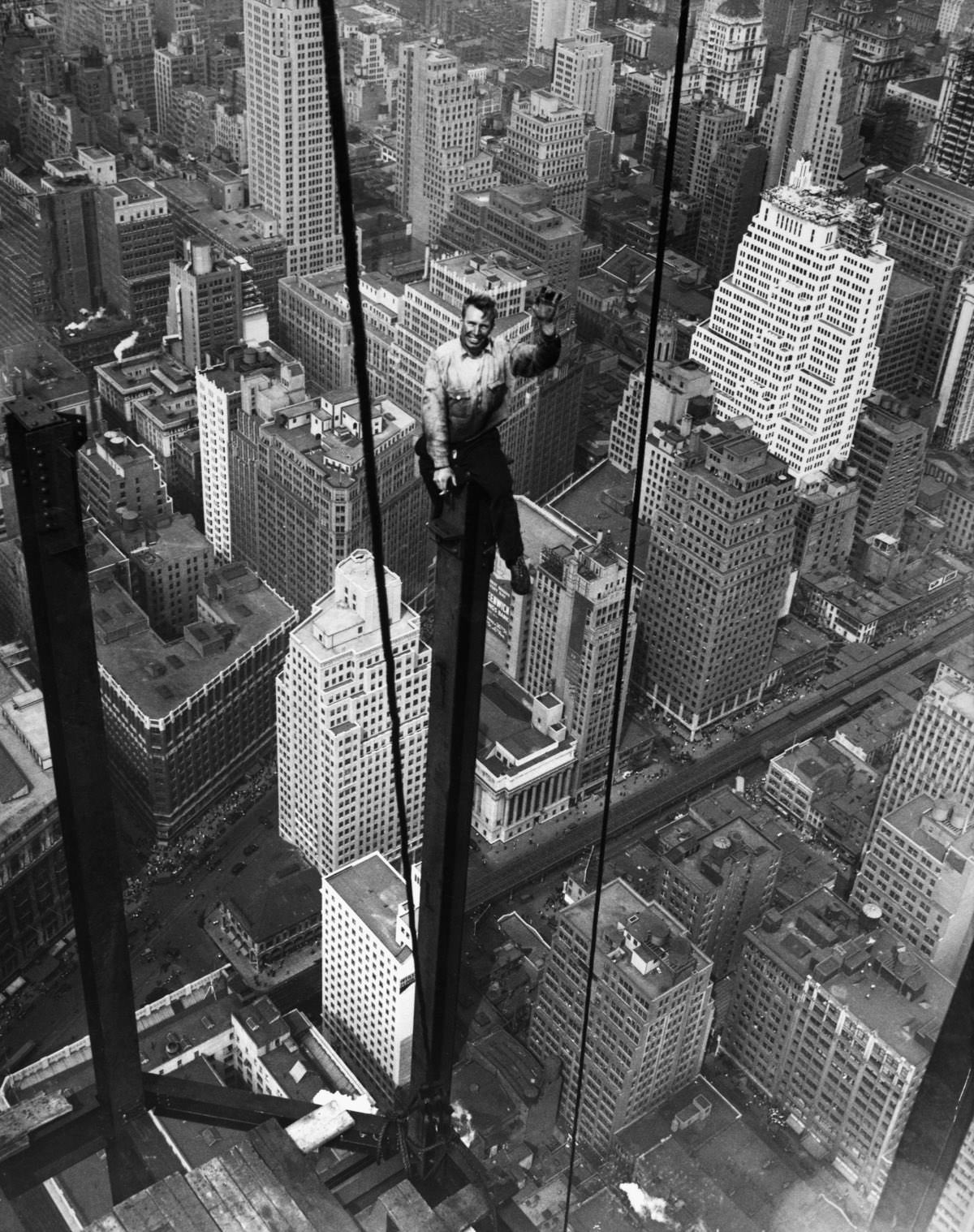 Carl Russell waves to his co-workers on the 88th floor of the Empire State Building, 1930.