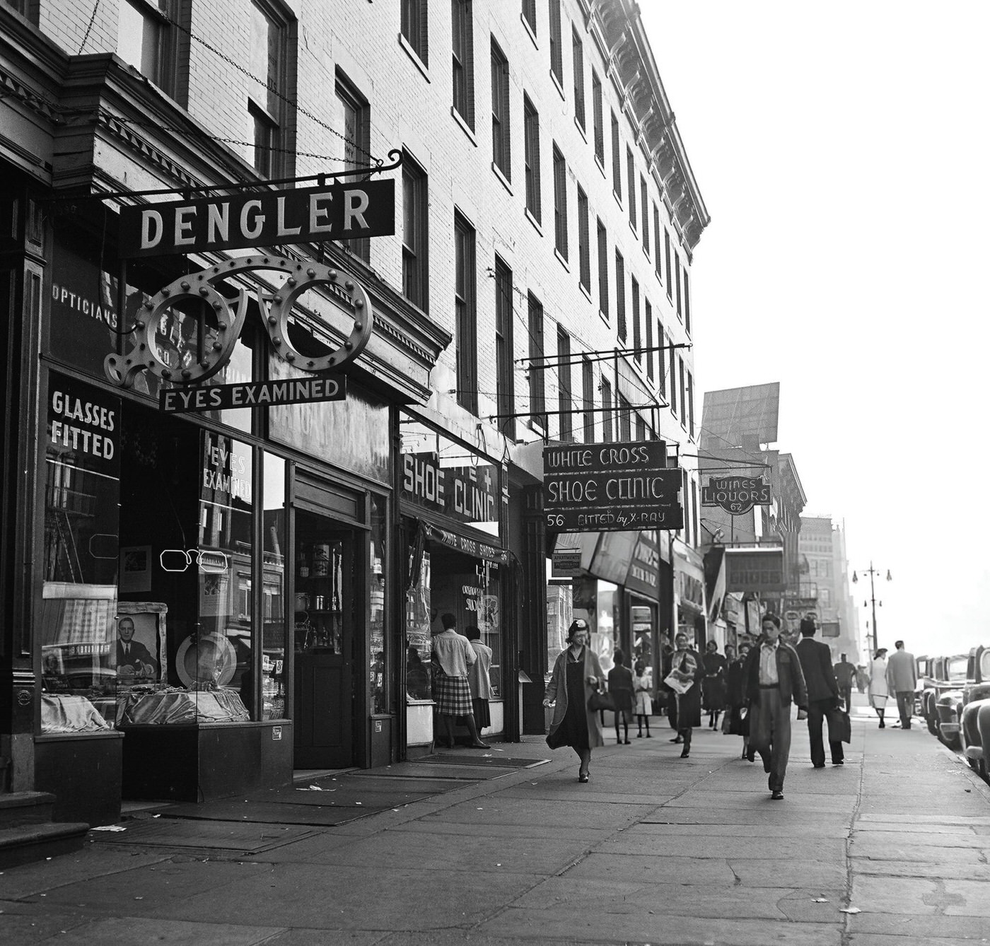 Heavy pedestrian traffic and storefronts along 125th Street in Harlem, 1948.