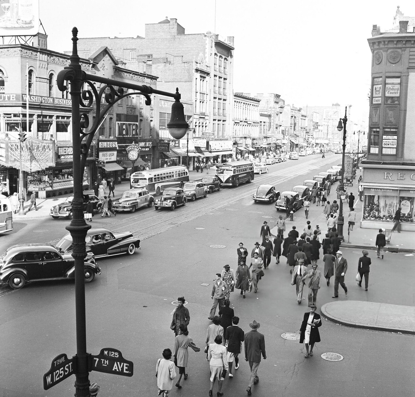 Pedestrian and vehicular traffic at the corner of 125th Street and 7th Avenue in Harlem, 1948.