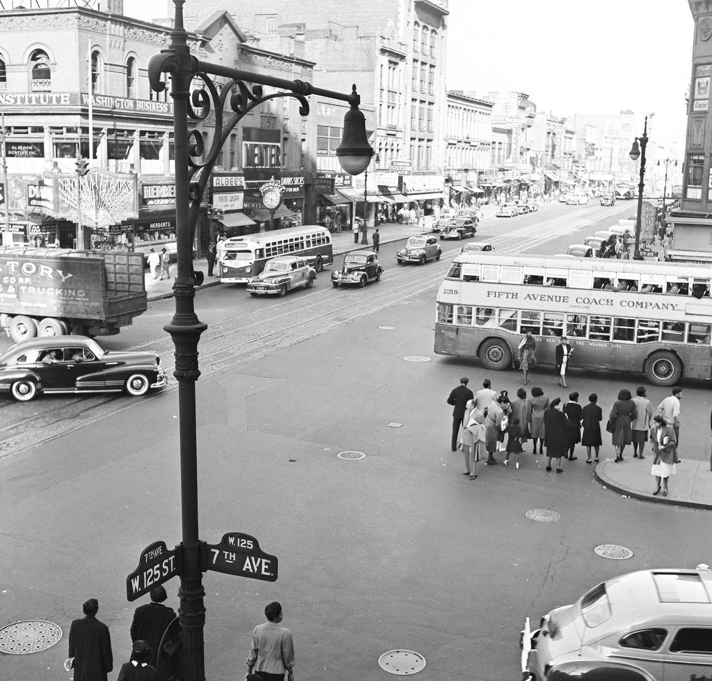 Pedestrian and vehicular traffic at the corner of 125th Street and 7th Avenue in Harlem, 1948.