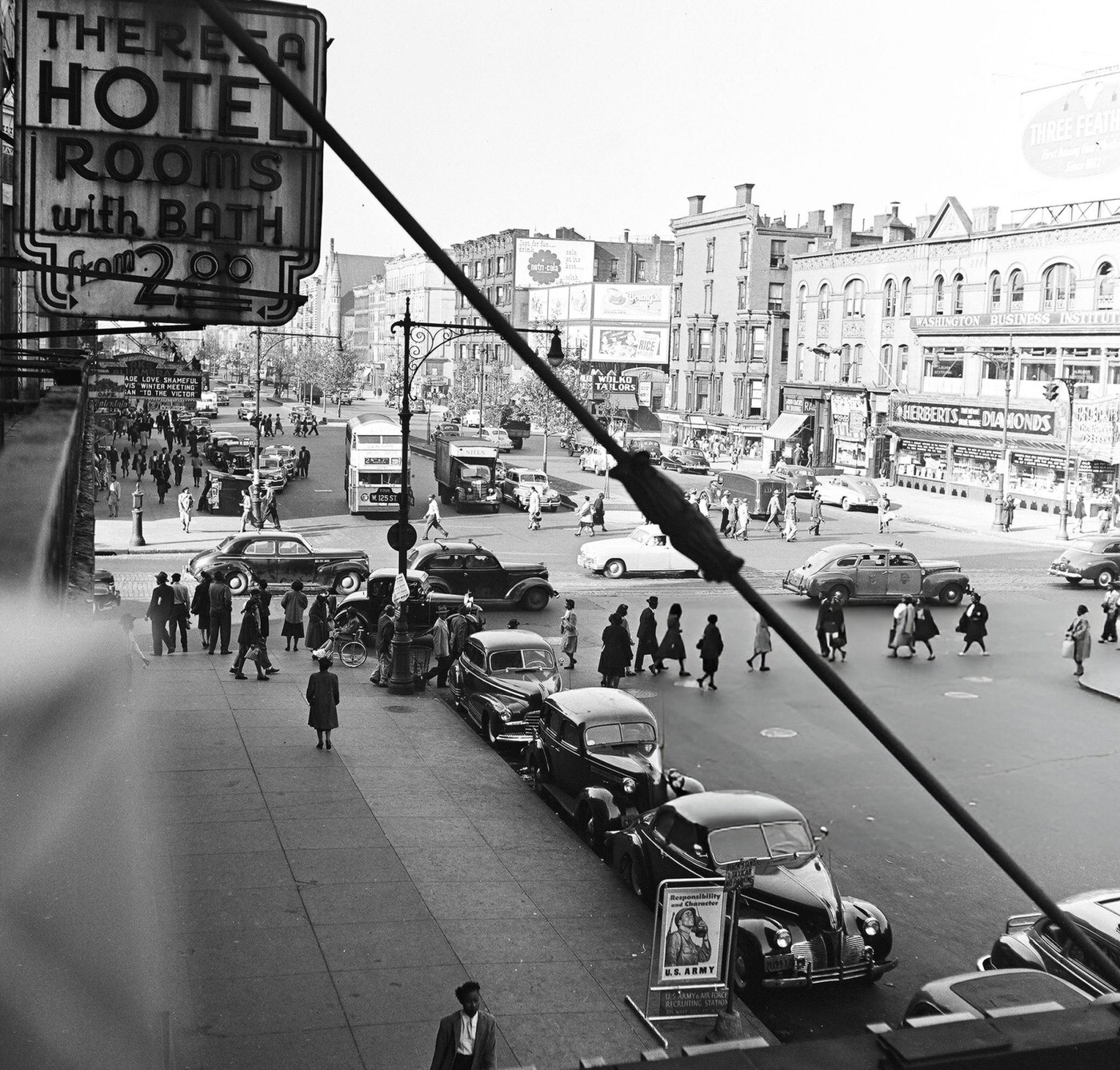 Pedestrian and vehicular traffic at the corner of 125th Street and 7th Avenue in Harlem, 1948.