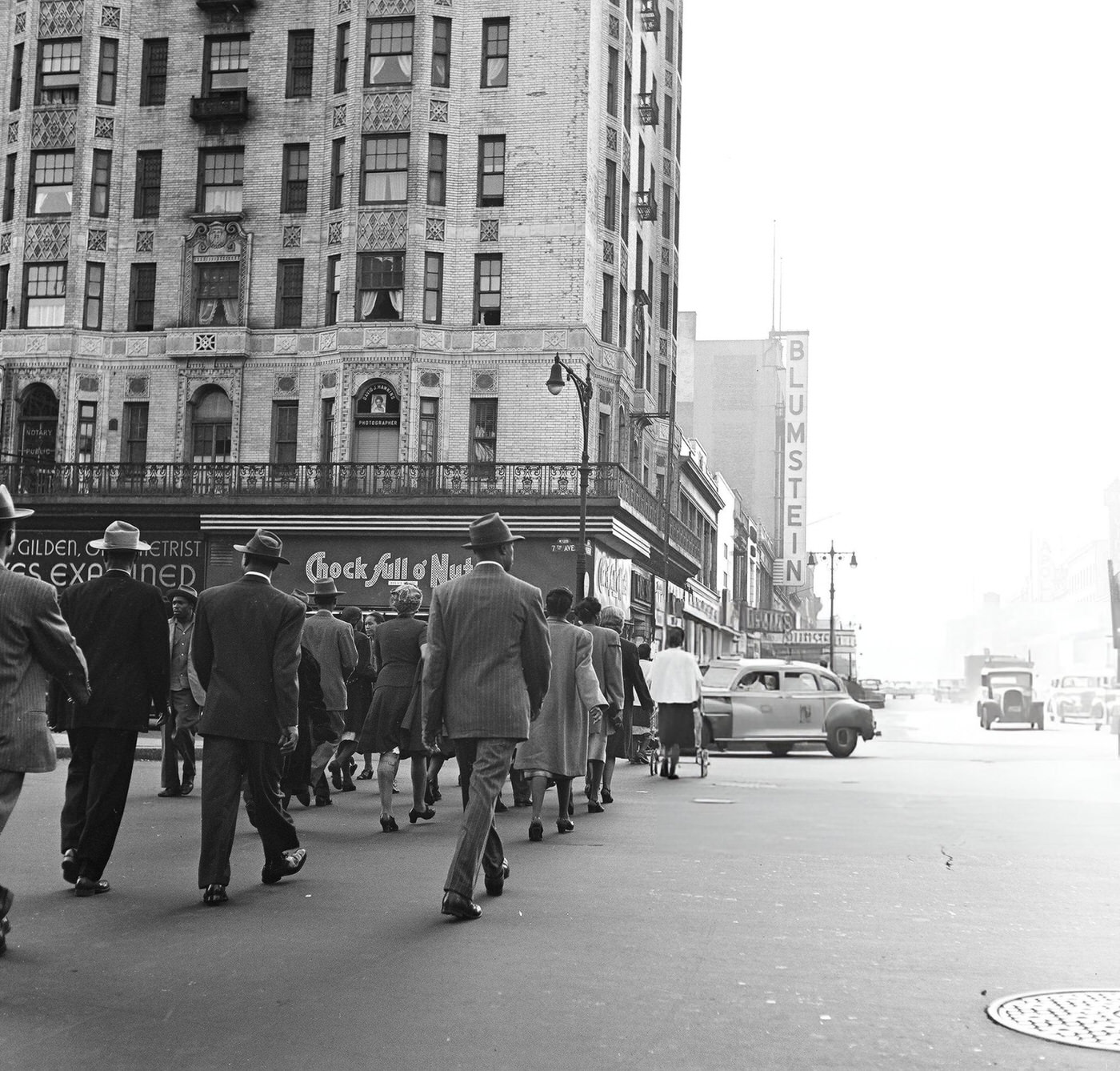 Pedestrian traffic crossing the street near 125th Street in Harlem, 1948.