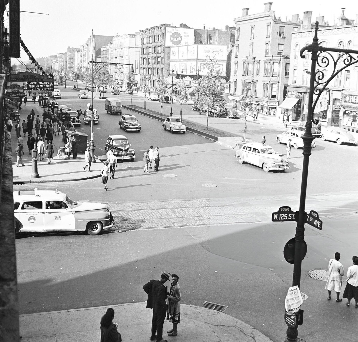Pedestrian and vehicular traffic at the corner of 125th Street and 7th Avenue in Harlem, 1948.