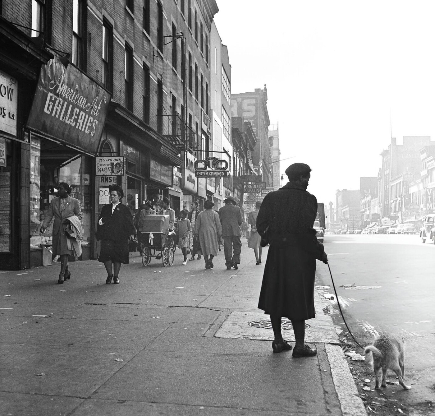 A woman walks her dog near 125th Street in Harlem, 1948.