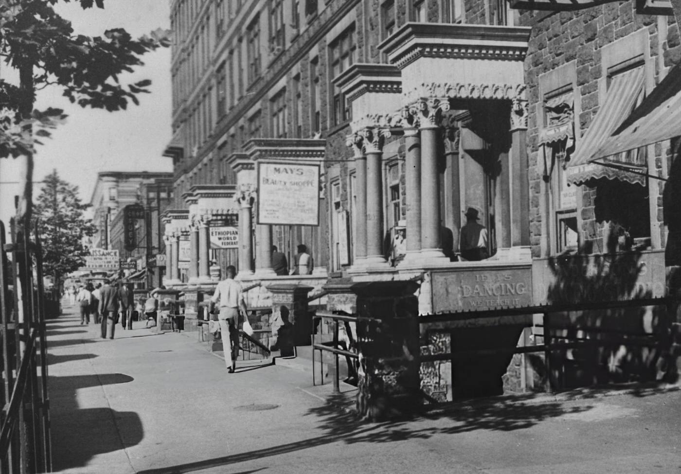 Signs reading 'If It's Dancing, We Teach it, ' 'Mays Beauty Shoppe, ' and 'Ethiopian World Federation' in Harlem, 1940s.