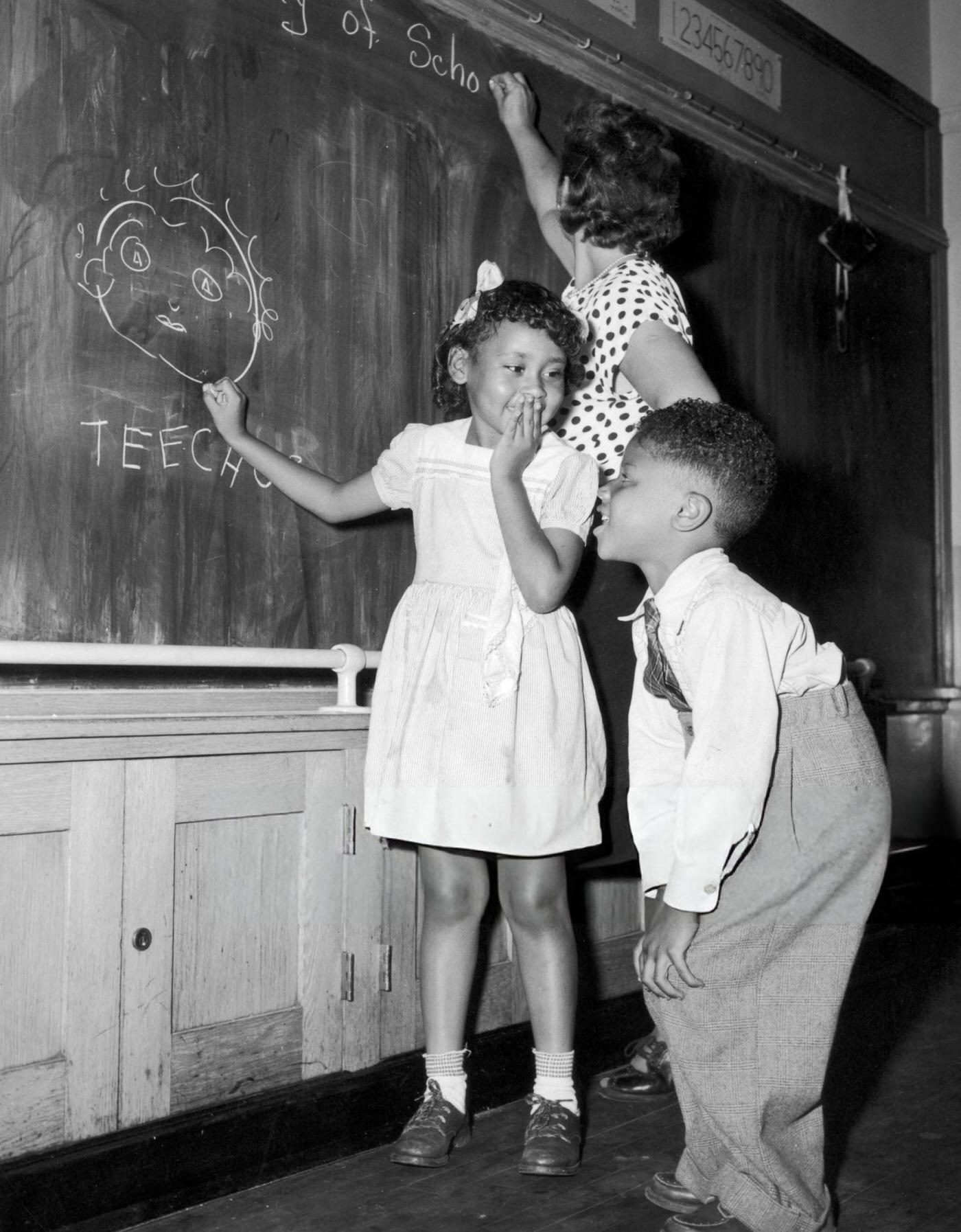 Joyce Payne and Vincent Baker draw a portrait of their teacher on their first day at a Harlem School, 1948.