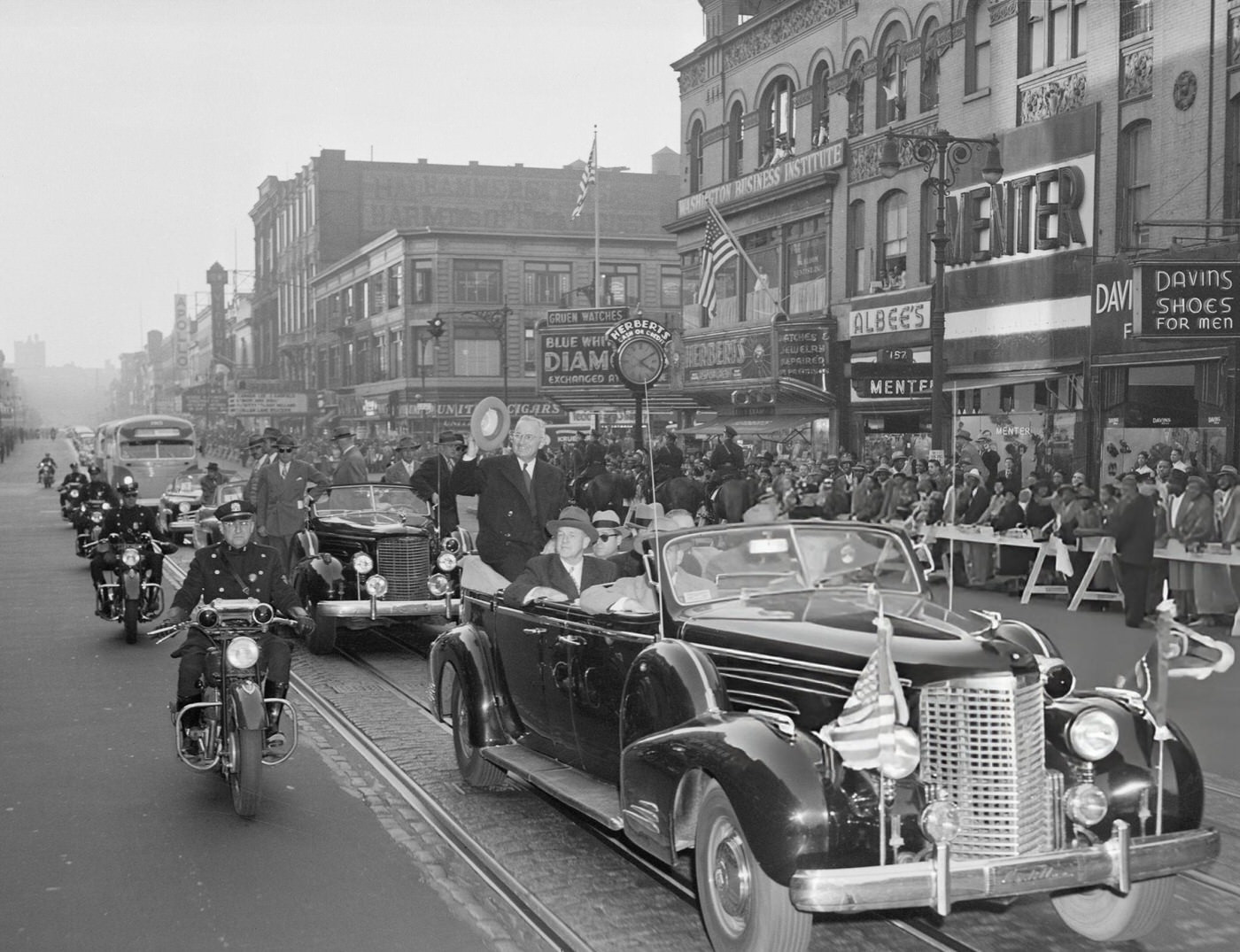 President Truman is cheered as he rides along 125th Street in Harlem, 1948.