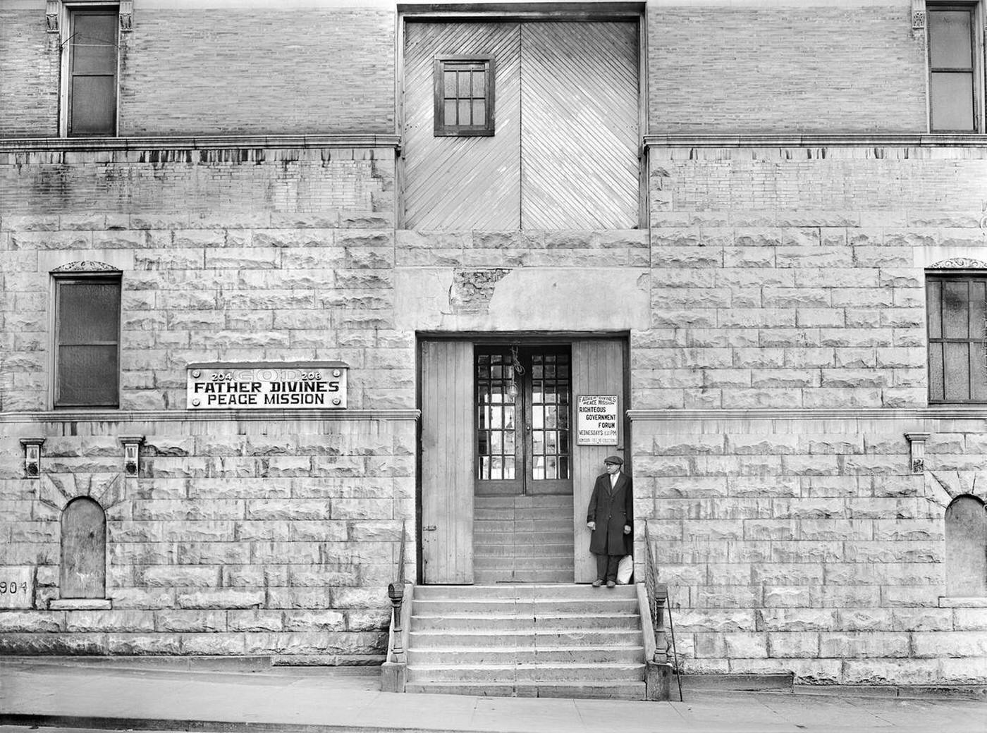 Man standing on the steps of Father Divine's Peace Mission, Harlem, 1941.