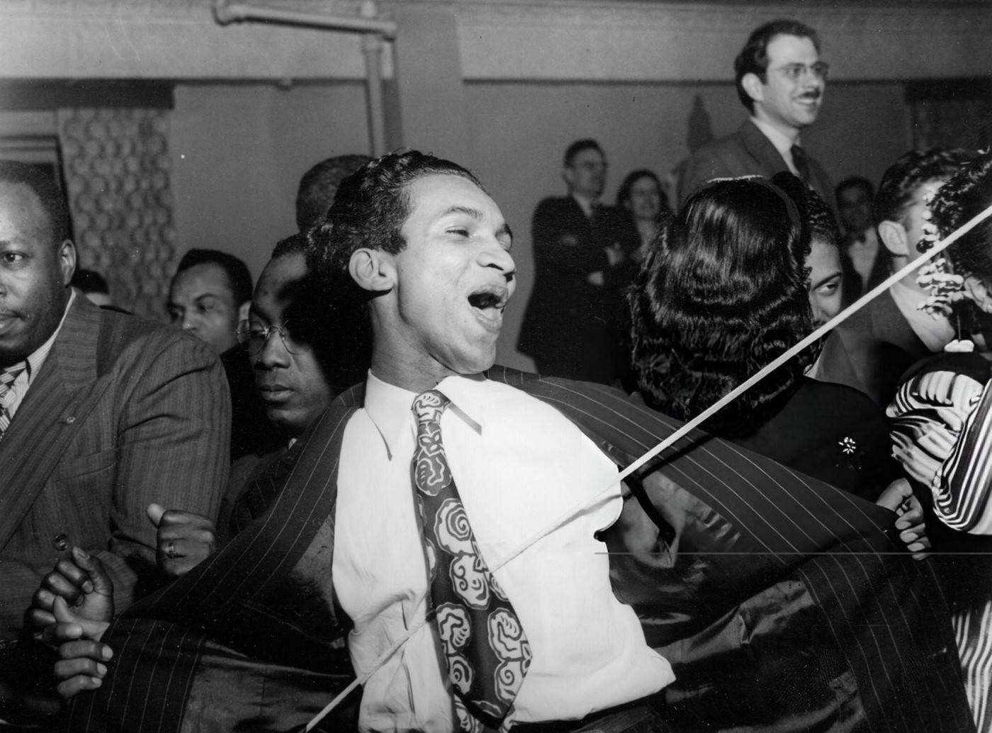 A young man joins in the dancing in Harlem, 1944.
