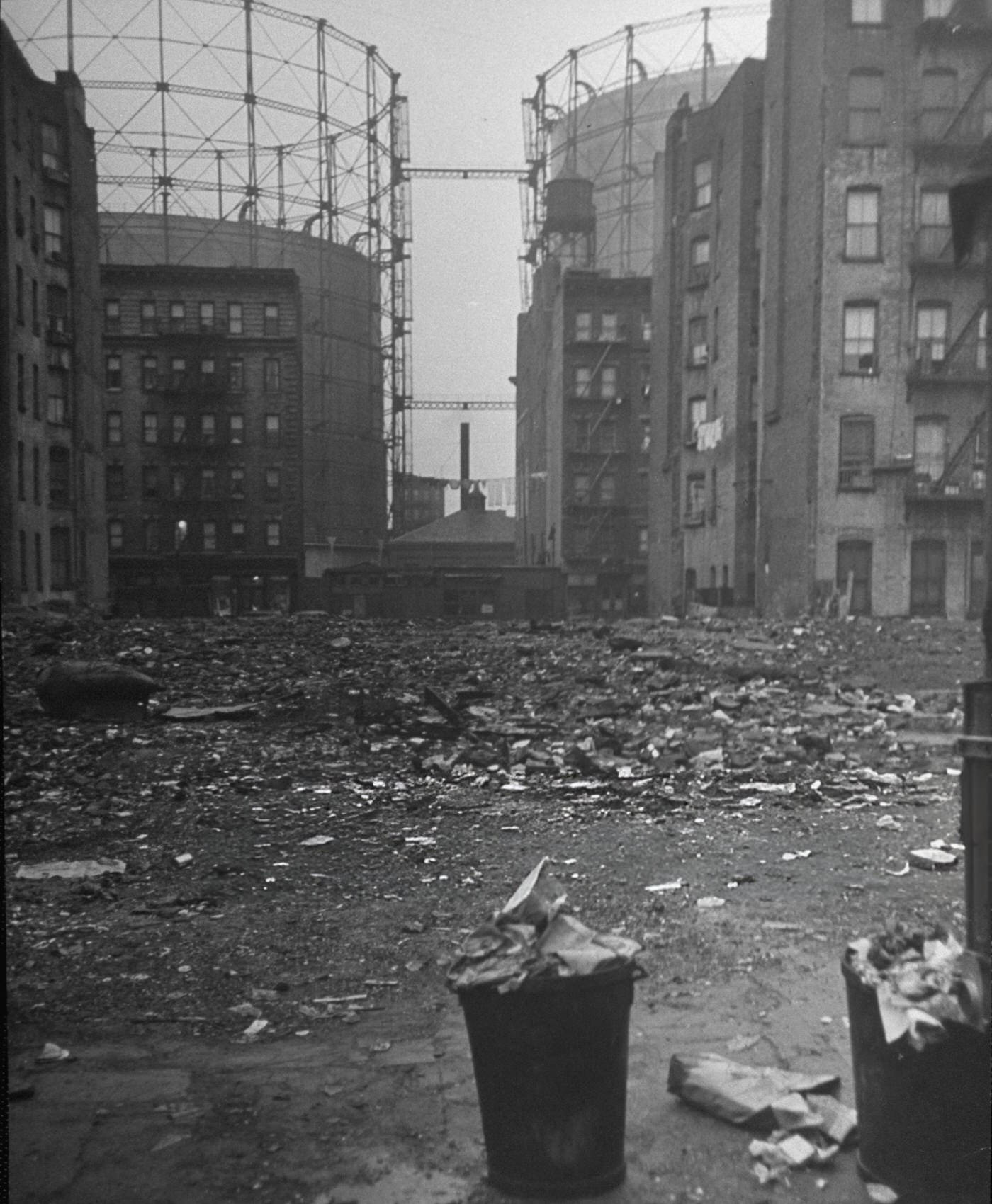 Litter and garbage filling a vacant lot in East Harlem, 1940s.