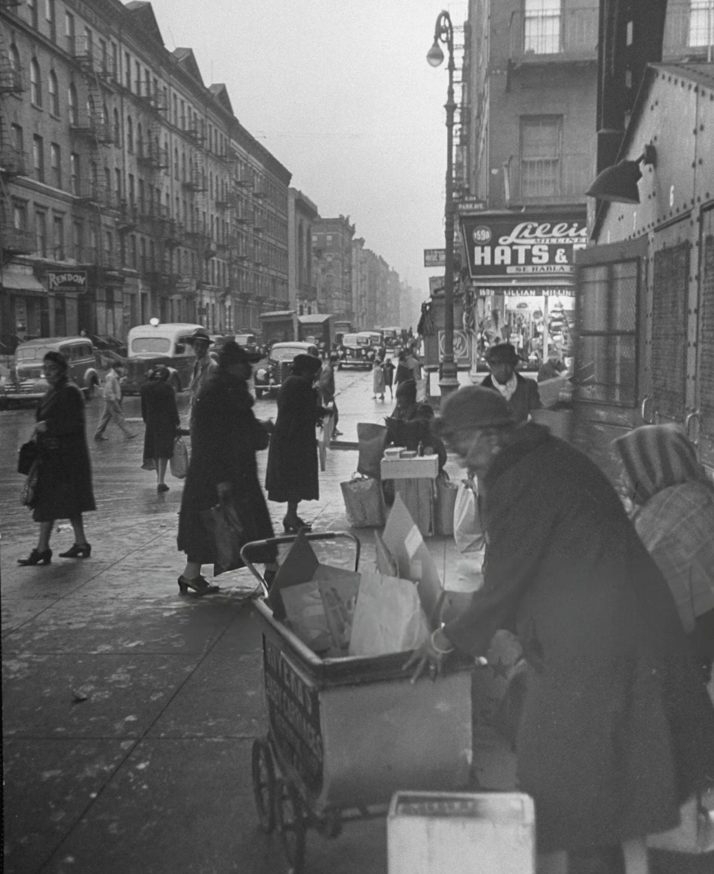 People bustling along a city sidewalk in East Harlem, 1940s.