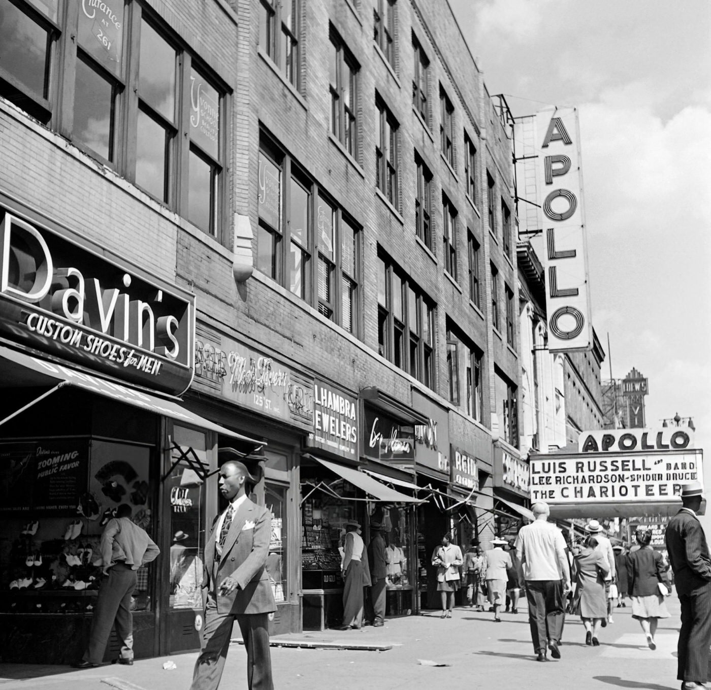 People pass by shops on 125th Street near the Apollo Theatre in Harlem, Manhattan, 1946.