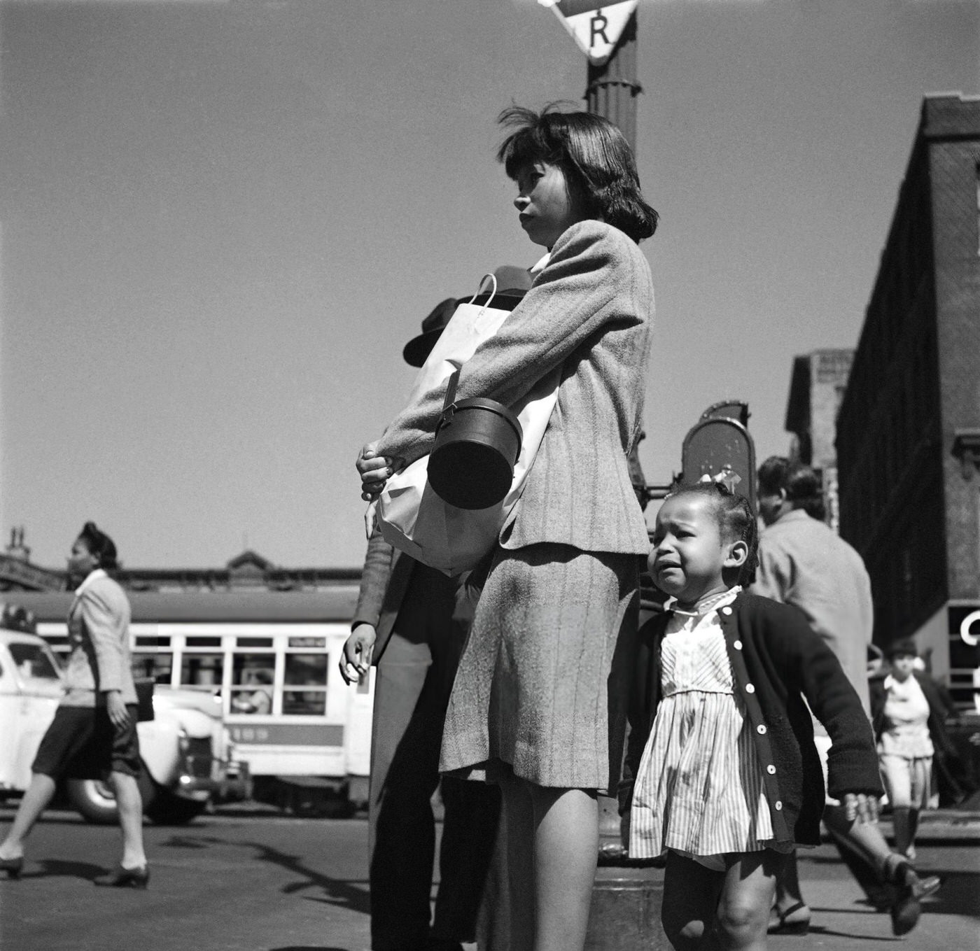 An African American woman and her little girl wait for a bus in Harlem, Manhattan, 1946.