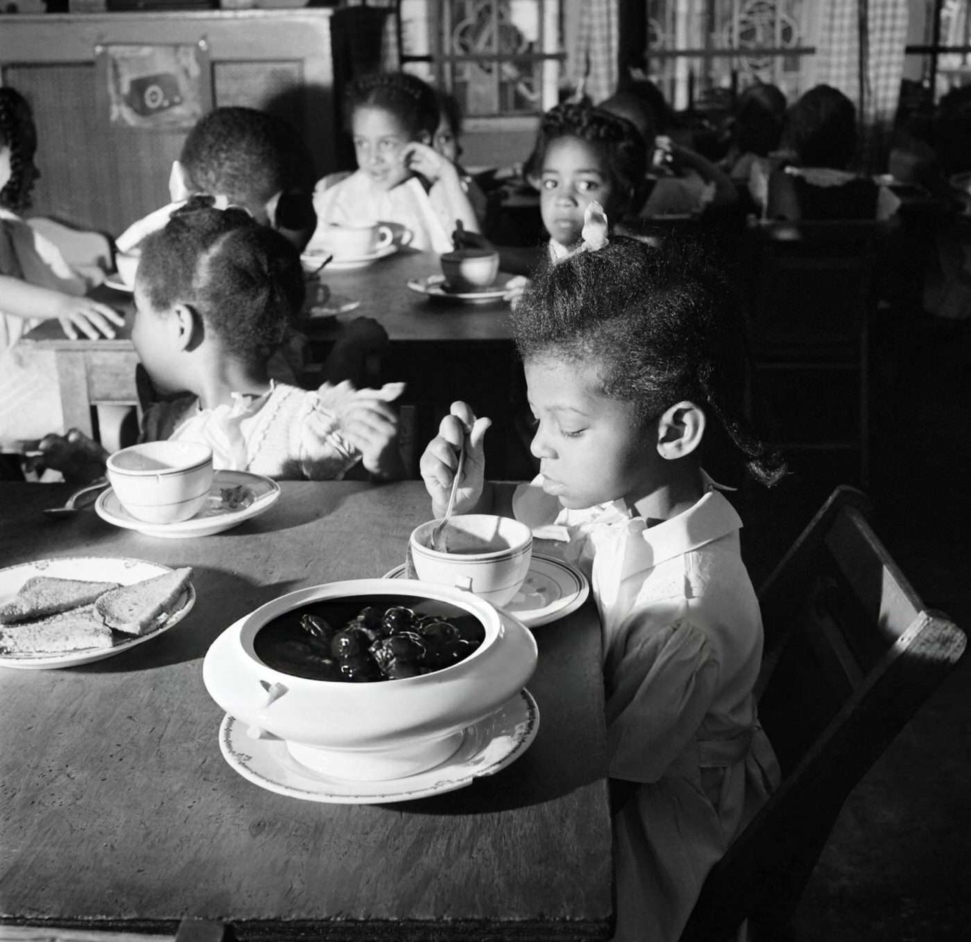 Children eat in a school canteen in Harlem, Manhattan, 1946.