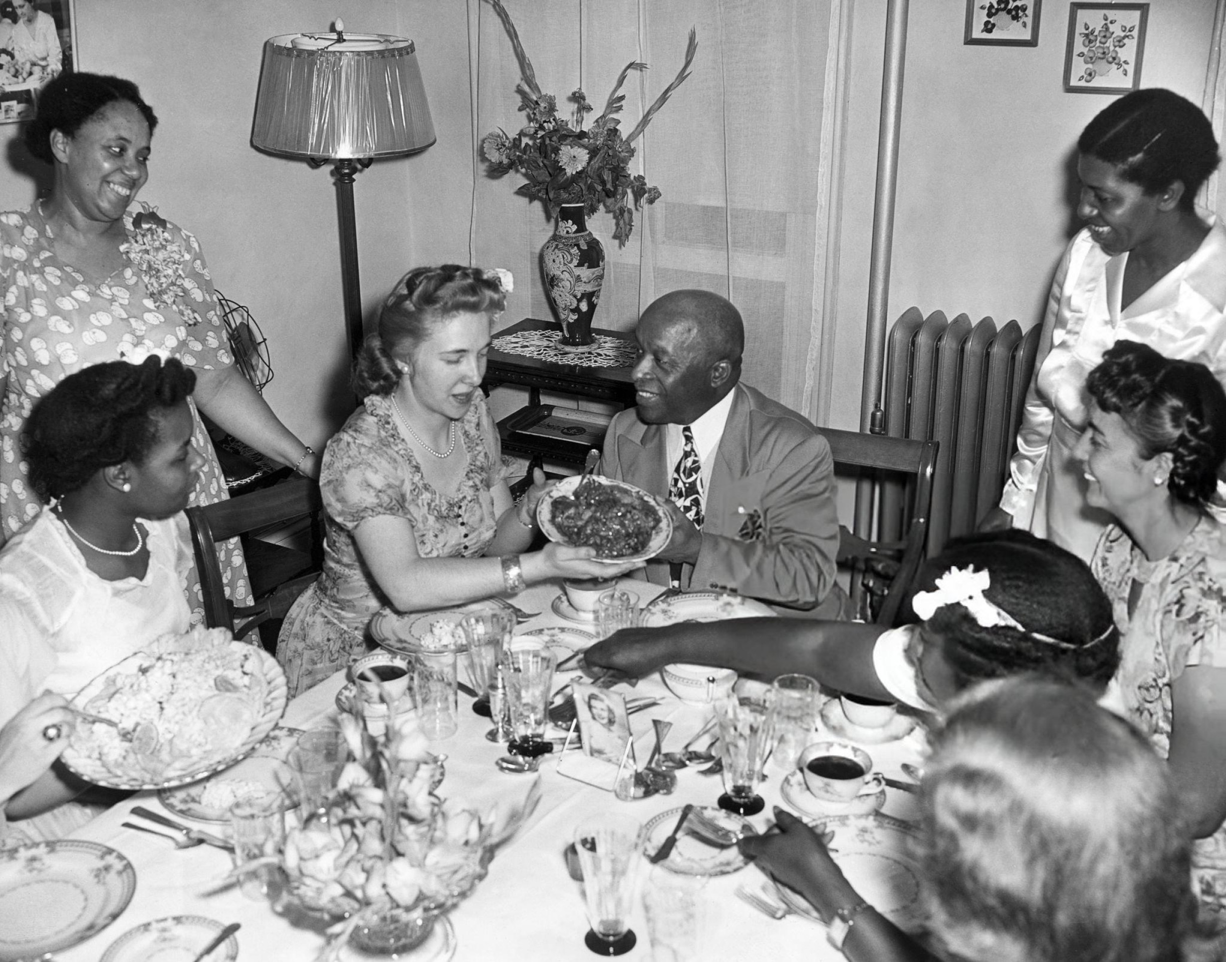 Father Divine eating a meal with his new wife at his Harlem home, 1940s.
