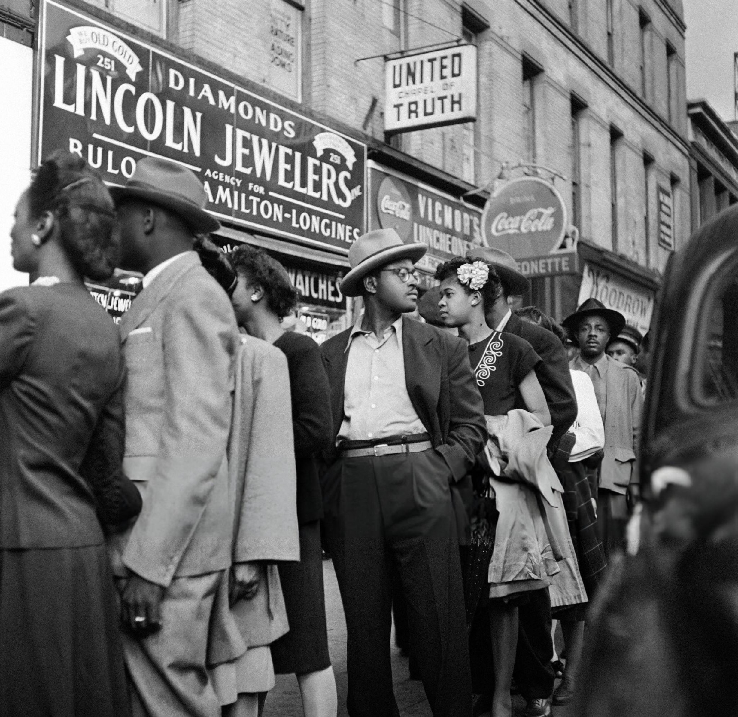 African American people wait in line at the entrance of a cabaret in Harlem, Manhattan, 1946.