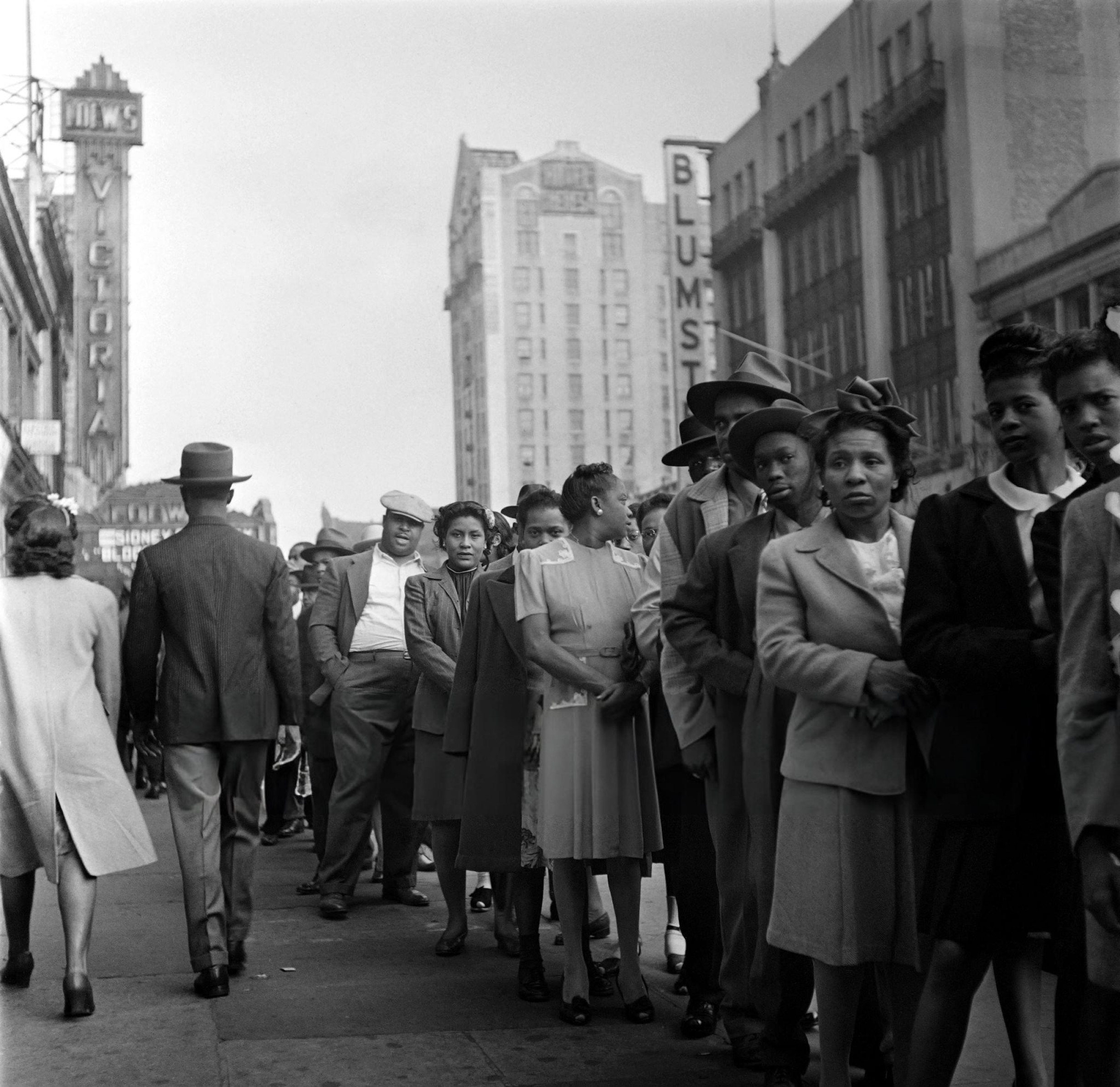 African American people wait in line at the entrance of a cabaret in Harlem, Manhattan, 1946.