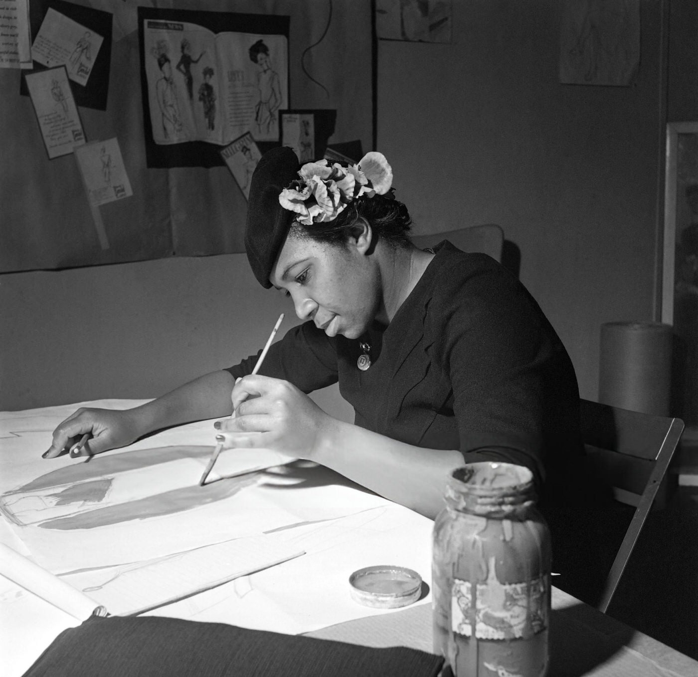 An African American woman takes a fashion drawing lesson in Harlem, Manhattan, 1946.