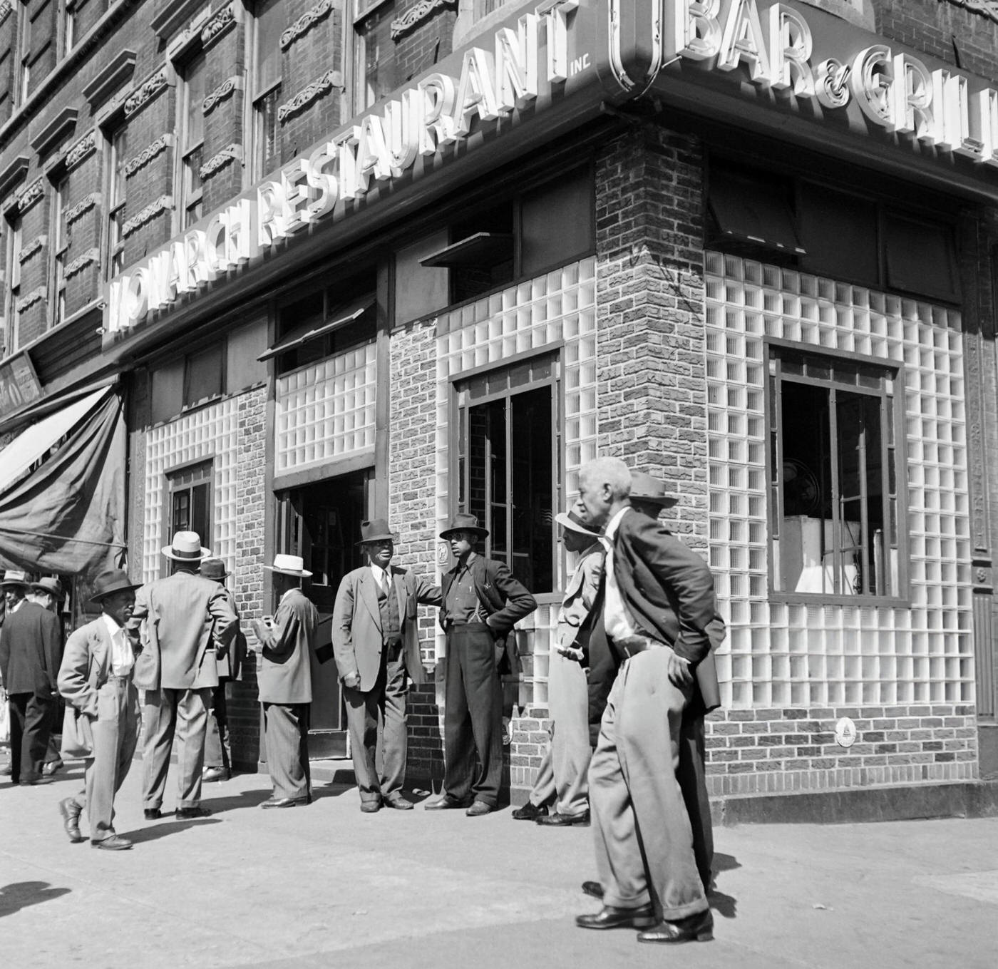 African American men stand in front of a restaurant in Harlem, 1946.