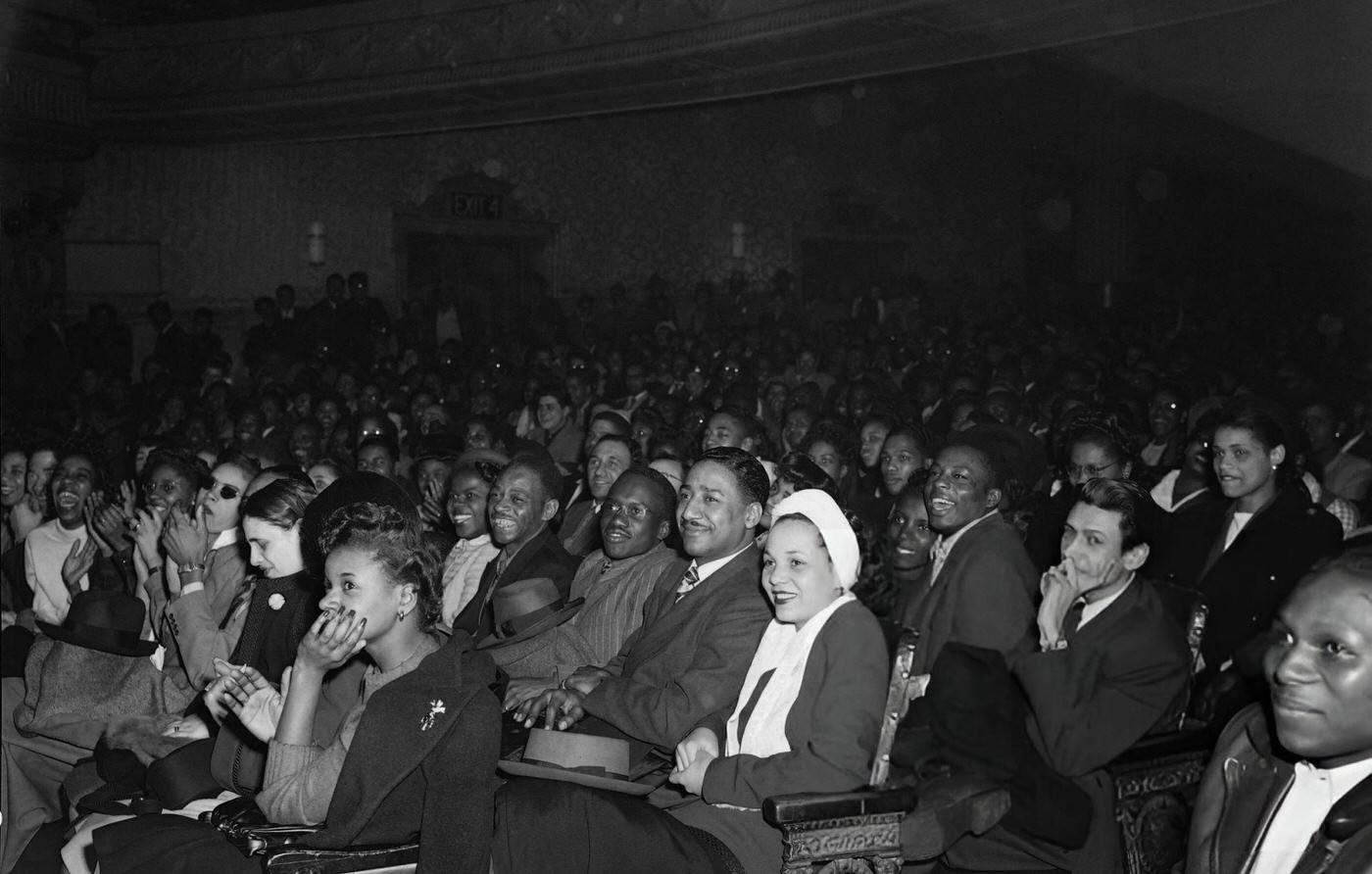 Spectators look at singer "Two-ton Boila" performing on the scene of the Apollo Theater in Harlem, 1946.