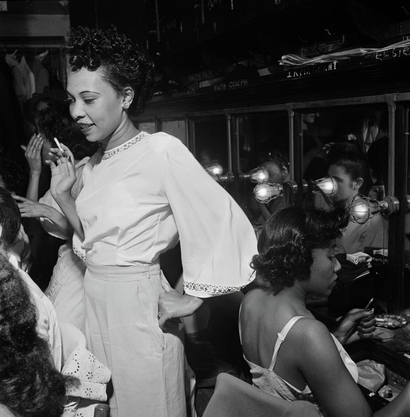 Cabaret dancers prepare in a dressing room in a night club in New York City, 1946.
