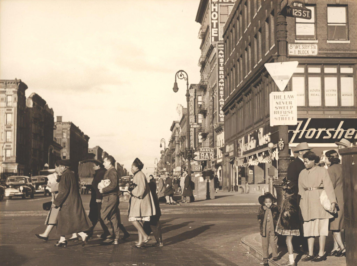 Rebecca at the intersection of 125th St. and 8th Av. in Harlem, 1947.