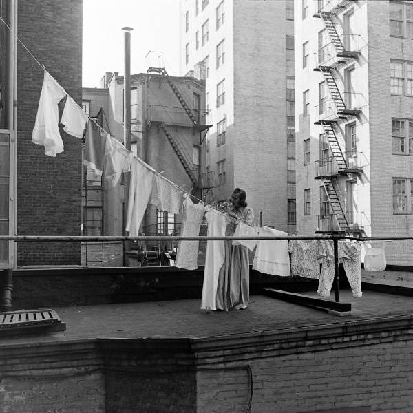 A woman hanging laundry on the roof of her building, New York City, 1939.