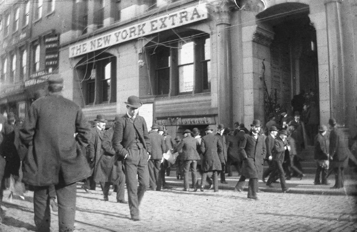 Crowds of men outside the New York Tribune building in lower Manhattan, 1884.