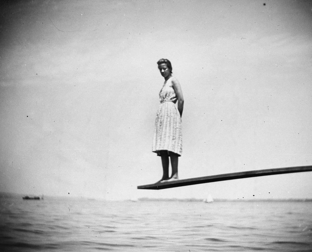 Maggie Ward stands on the end of a diving board at Coney Island, 1888.