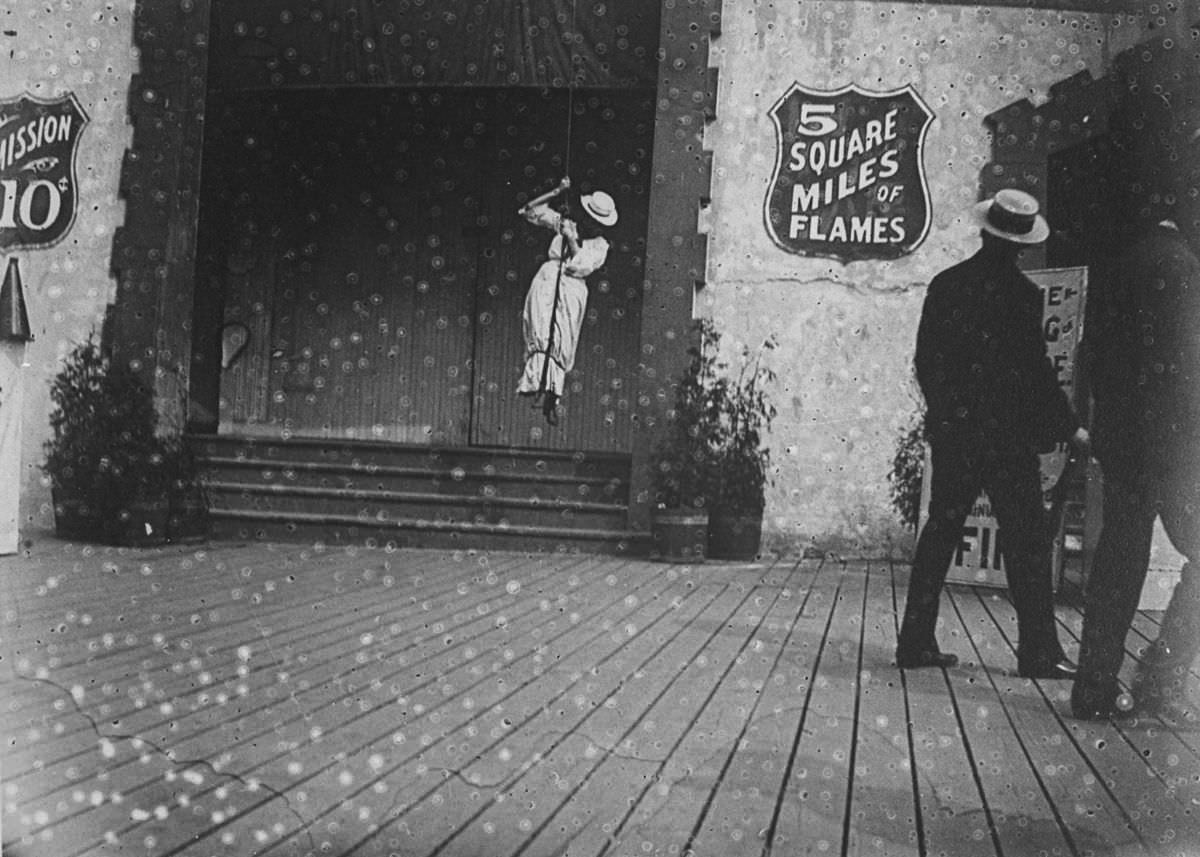 A woman swings on a rope at Coney Island, 1890.