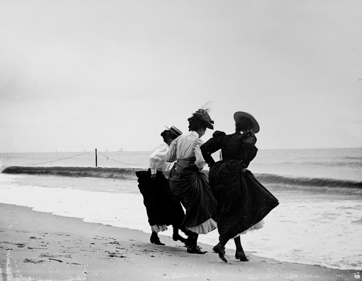 Gertrude Hubbell, Ruth Peters, and Mildred Grimwood play near the water at Arverne, Queens.