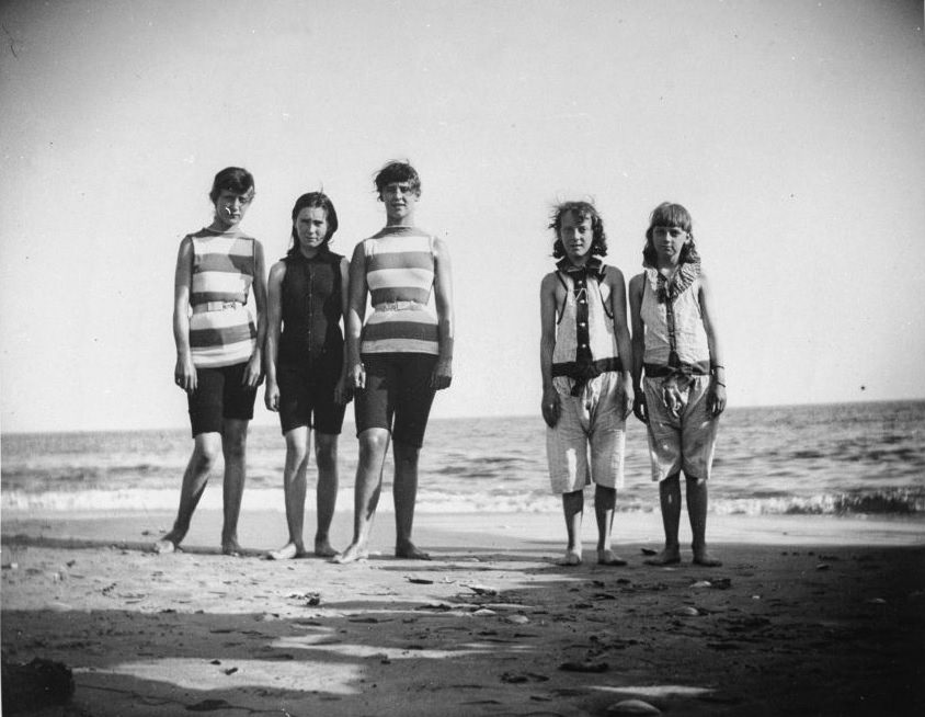 Five girls who will be competing in a swimming match posing by the shoreline at Coney Island, Brooklyn, NY, 1887.