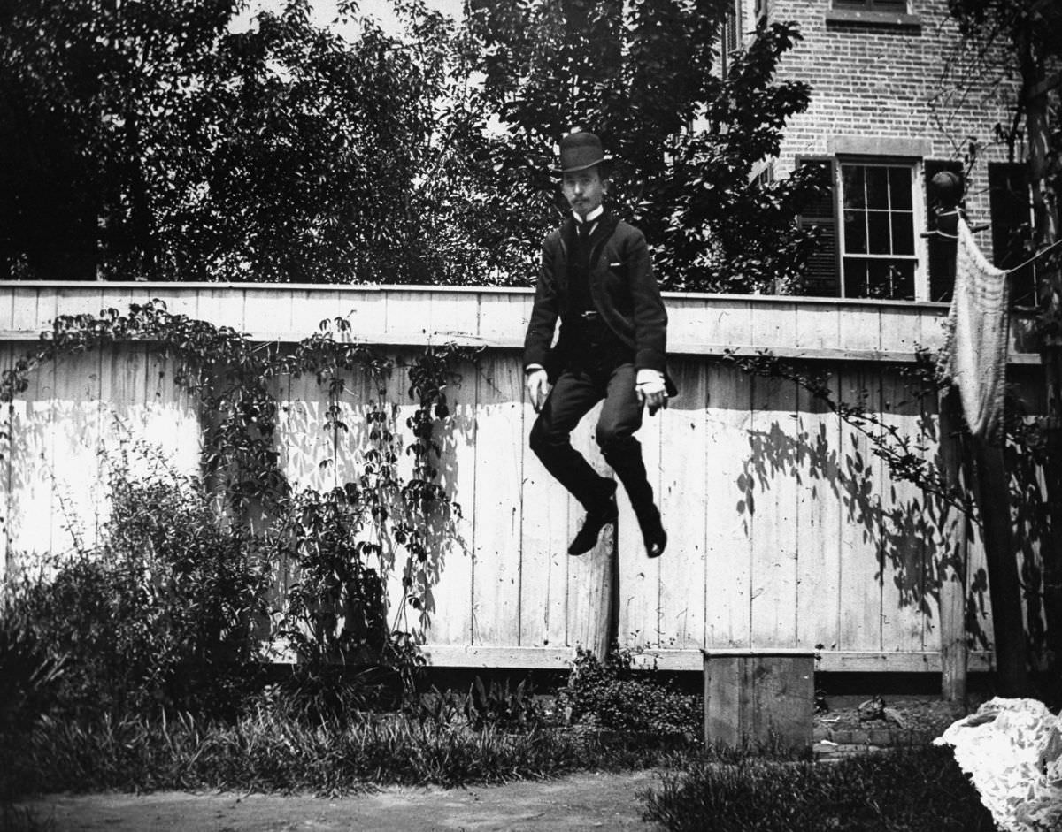 J.M. Cornell jumps in the backyard at 314 Livingston Street, 1886.