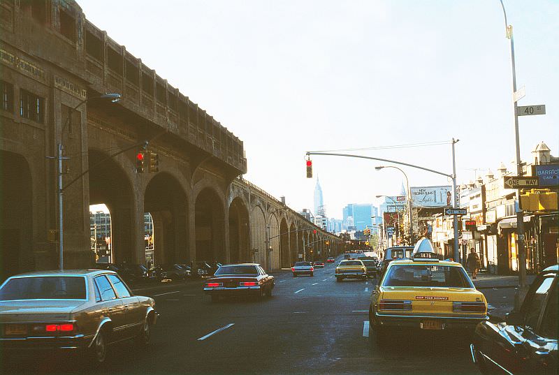 Queens Boulevard at 40th Street, subway viaduct at the left, Empire State Building in the distance.
